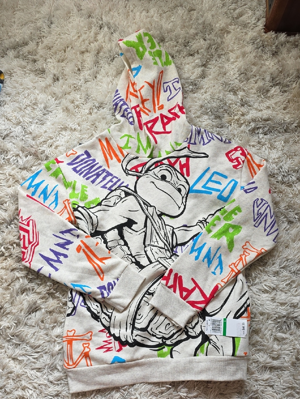 Nickelodeon Cream Hoodie with Black Turtle Graphic and Multicolor Graffiti